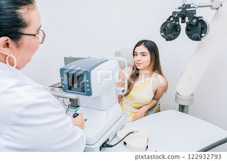 Woman patient having consultation with optometrist in office. Optometrist with female patient in the autorefractor 122932793