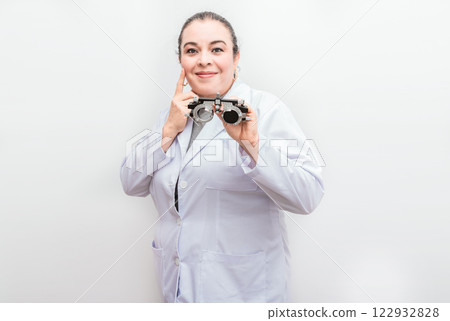 Smiling ophthalmologist holding a messbrille isolated. Portrait of optometrist holding a messbrille lens isolated 122932828