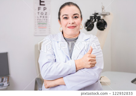 Optometry specialist with thumb up. Smiling eye doctor with thumb up in office, Female optometrist with thumb up in the laboratory 122932833