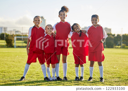 Girl team, kids on soccer field and sports development for happy girls in group portrait together. Teamwork, football and proud female children from Brazil on grass before football game or training. 122933100