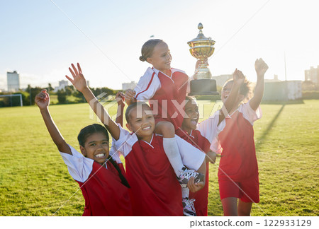 Sports. soccer and young girls with trophy celebrate, happy and excited outside on field for their victory. Team, players and female children are victorious, winners and champions for their game. 122933129