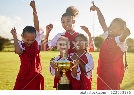 Children, football trophy and winning team of sports competition on soccer field for celebration of goal, win and teamwork after a match outdoors. Youth, kids or girls club after a tournament game 122933186