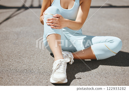Sports injury, knee pain and fitness woman sitting on tarmac road outside massaging leg for osteoporosis and fibromyalgia. Health, tired and female with orthopedic, arthritis and exercise problem Sports injury, knee pain and fitness woman sitting on tarmac road outside massaging leg for osteoporosis and fibromyalgia. Health, tired and female with orthopedic, arthritis and exercise problem 122933282
