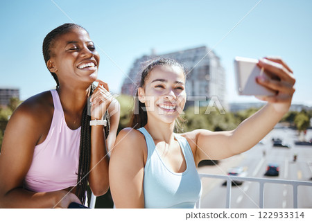 Phone, exercise and friends taking a selfie after a workout or yoga training session outdoor. Happy smile women enjoying fresh air and fitness, excited and bonding with wellness and health in a city Phone, exercise and friends taking a selfie after a workout or yoga training session outdoor. Happy smile women enjoying fresh air and fitness, excited and bonding with wellness and health in a city 122933314