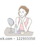 A woman happily doing skin care while looking at the mirror 122933350