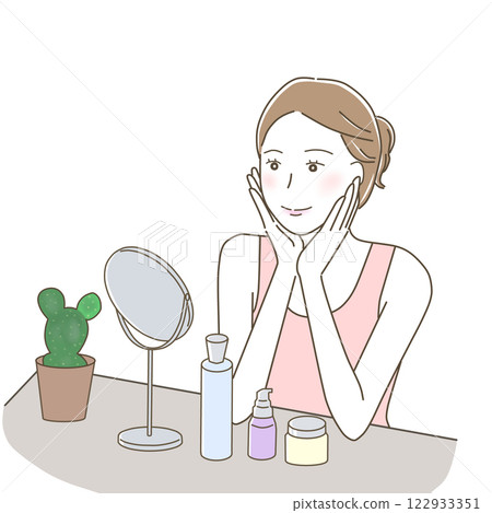 A woman happily doing skin care while looking at the mirror A woman happily doing skin care while looking at the mirror 122933351