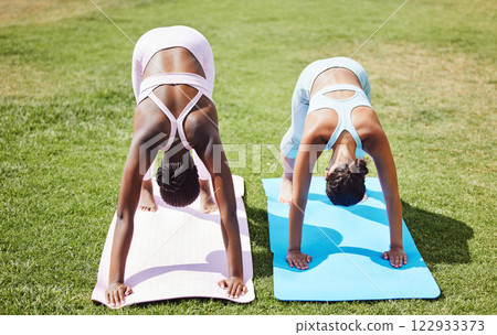 Yoga women, downward dog pose and outdoor grass workout for balance, energy and zen wellness. Calm, healthy and friends pilates exercise, summer training and stretching body together in on park lawn Yoga women, downward dog pose and outdoor grass workout for balance, energy and zen wellness. Calm, healthy and friends pilates exercise, summer training and stretching body together in on park lawn 122933373