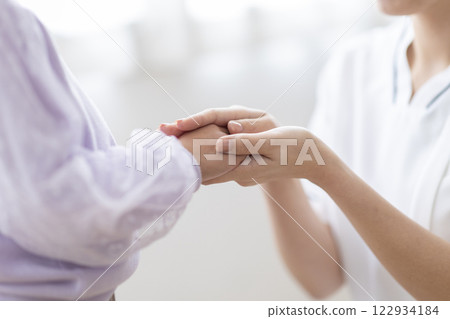 A nurse holding a patient's hand 122934184