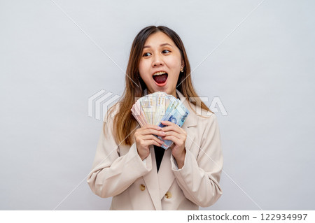 Excited Taiwanese woman holding stack of cash - financial success and wealth, lucky winner with big salary, bonus and financial reward Excited Taiwanese woman holding stack of cash - financial success and wealth, lucky winner with big salary, bonus and financial reward 122934997