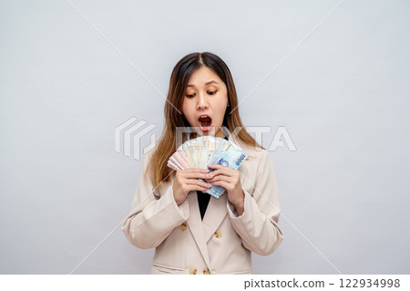 Excited Taiwanese woman holding stack of cash - financial success and wealth, lucky winner with big salary, bonus and financial reward Excited Taiwanese woman holding stack of cash - financial success and wealth, lucky winner with big salary, bonus and financial reward 122934998