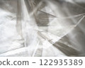 Crumpled clear plastic background, abstract glossy broken surface texture with creases 122935389