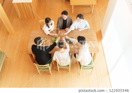 Men and women toasting at a home party Men and women toasting at a home party 122935546
