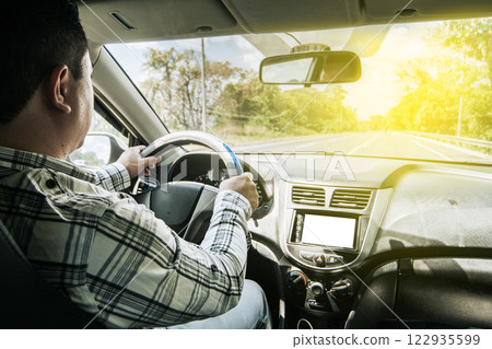 inside view of a man driving a car, A person driving with hands on the wheel, Man's hands on the wheel of the car, Concept of hands on the wheel of a car inside view of a man driving a car, A person driving with hands on the wheel, Man's hands on the wheel of the car, Concept of hands on the wheel of a car 122935599