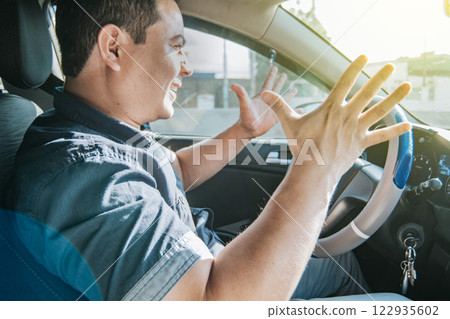 Impatient driver yelling, portrait of angry driver yelling in his car, stressed driver man yelling at other driver, concept of impatient driver yelling 122935602