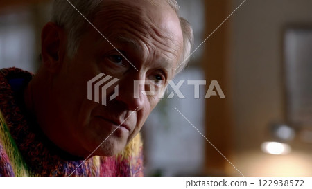 Elderly man listening and reacting with slight head movements 122938572