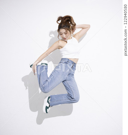 Cute woman dancing 122940580