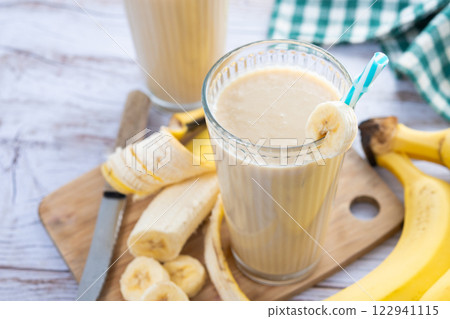 Fresh banana smoothie on white wooden table 122941115