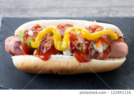 Sonoran hot dog. Traditional Mexican hot dog on wooden table 122941116