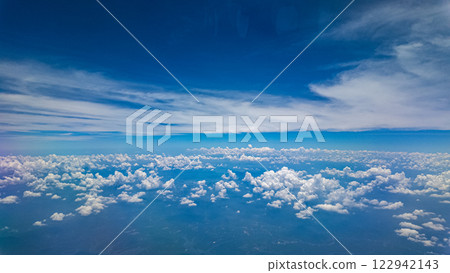 View from airplane window white clouds above the world 122942143