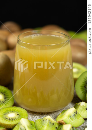 Kiwi juice in a glass among fresh kiwi fruits. 122942146