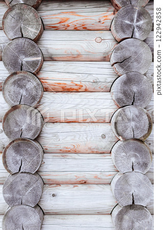 texture of a wooden wall made of logs, light wood texture. wooden house. vertical image texture of a wooden wall made of logs, light wood texture. wooden house. vertical image 122942858