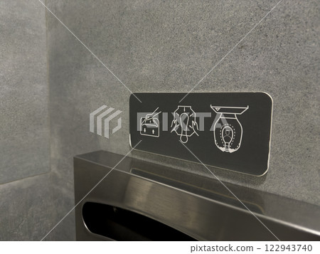 Sign on wall showing how to use toilet rim pad for hygiene Sign on wall showing how to use toilet rim pad for hygiene 122943740