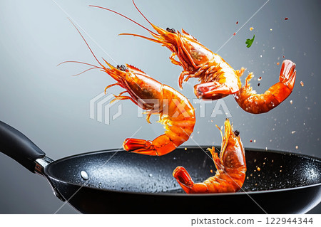 Golden-Brown Fried Prawns Leaping From Frying Pan in Action Shot Golden-Brown Fried Prawns Leaping From Frying Pan in Action Shot 122944344