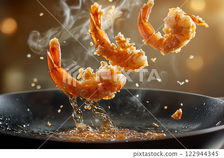 Golden-Brown Fried Prawns Leaping From Frying Pan in Action Shot 122944345