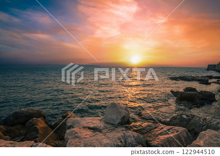 Rocky seashore near Akko city in the evening. Sunset over the sea 122944510