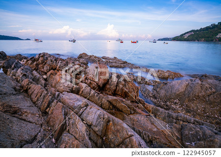 Long exposure image of Dramatic sky seascape with rock in sunset scenery background Long exposure image of Dramatic sky seascape with rock in sunset scenery background 122945057