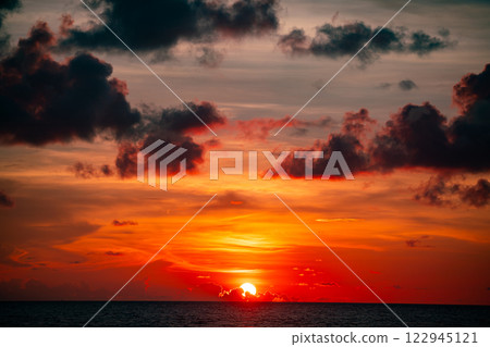 Amazing colorful clouds in sunset or sunrise sky over sea nature landscape background 122945121