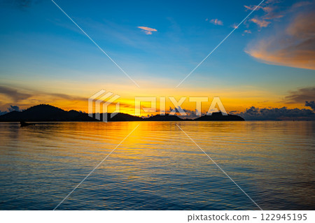 Landscape of colorful clouds in sunset or sunrise sky over sea with reflection in the tropical sea,Beautiful seascape scenery,Amazing light of nature Landscape nature background Landscape of colorful clouds in sunset or sunrise sky over sea with reflection in the tropical sea,Beautiful seascape scenery,Amazing light of nature Landscape nature background 122945195