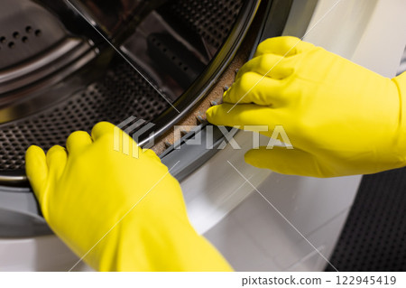 Dirty moldy washing machine sealing rubber and drum close up. Mold, dirt and limescale in washing machine.  122945419