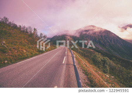 Driving a car on the road on Senja Island. View from the windshield. Norway, Europe Driving a car on the road on Senja Island. View from the windshield. Norway, Europe 122945591