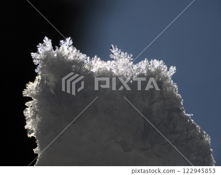 Snow crystals snowflakes detail close up in winter season Snow crystals snowflakes detail close up in winter season 122945853