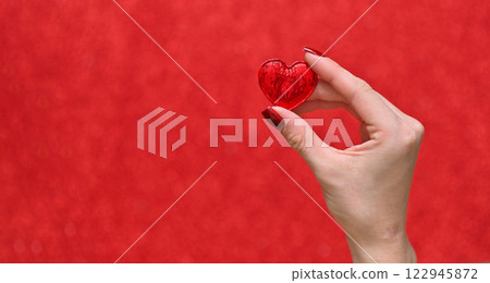 A heart in her hands on the background A heart in her hands on the background 122945872