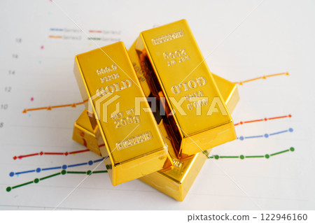 Gold bars on graph paper, finance trading investment business currency. Gold bars on graph paper, finance trading investment business currency. 122946160