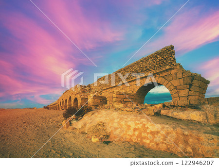 Seascape during sunset. Old aqueduct in Caesarea, Israel 122946207