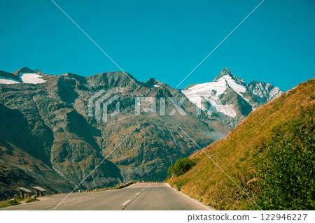 Mountain landscape with mountain road and sunset sky. Grossglockner High Alpine Road. Austria, Europe Mountain landscape with mountain road and sunset sky. Grossglockner High Alpine Road. Austria, Europe 122946227