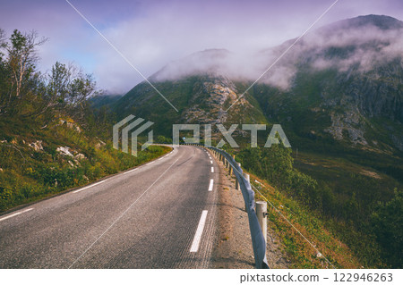 Driving a car on a mountain road on the island of Senja. View from the windshield. Norway, Europe Driving a car on a mountain road on the island of Senja. View from the windshield. Norway, Europe 122946263