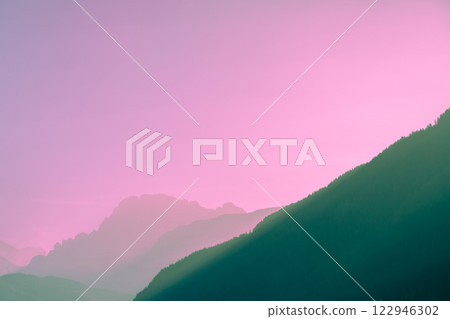 Silhouette of mountains against the pink sunset sky 122946302