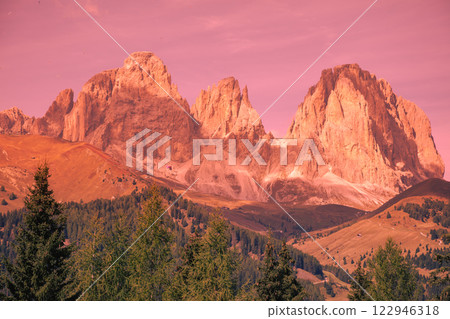 Mountain landscape in the evening. The Dolomites Alps against the sunset sky. Sella Pass, Grohmannspitze, Selva di Val Gardena, Bolzano, Italy Mountain landscape in the evening. The Dolomites Alps against the sunset sky. Sella Pass, Grohmannspitze, Selva di Val Gardena, Bolzano, Italy 122946318