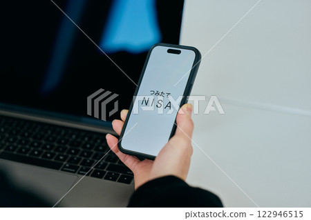 A young man in his twenties operating a smartphone 122946515