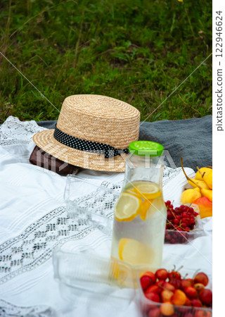 Summer picnic setting with straw hat and refreshing lemonade Summer picnic setting with straw hat and refreshing lemonade 122946624