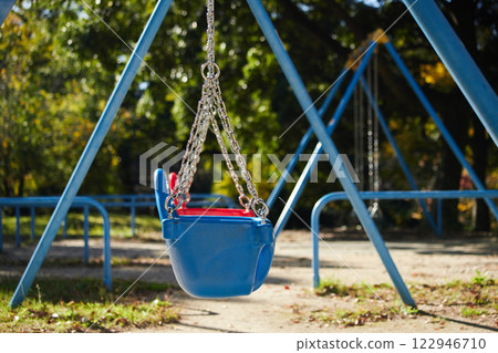 Autumn park scenery with swings for children 122946710