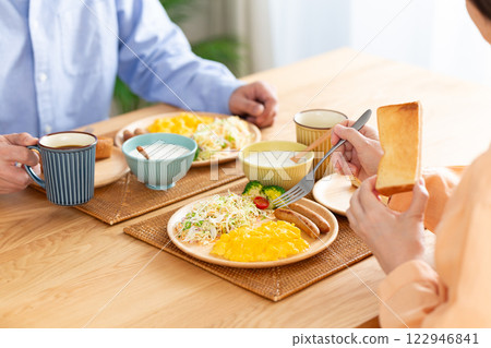 A middle-aged couple eating a Western-style breakfast A middle-aged couple eating a Western-style breakfast 122946841