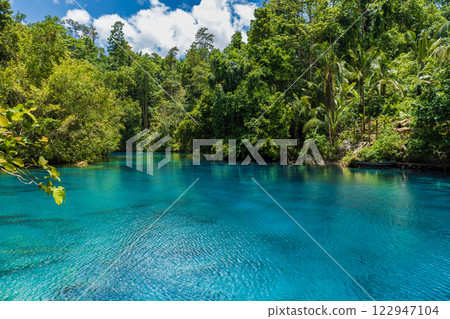 Blue lake with crystal fresh water in tropical forest in Indonesia. Blue lake with crystal fresh water in tropical forest in Indonesia. 122947104