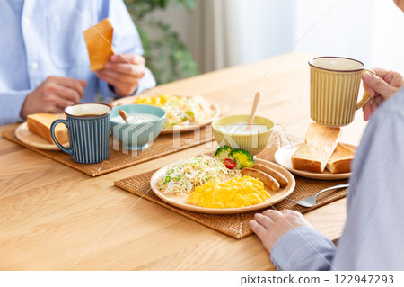 A middle-aged couple eating a Western-style breakfast 122947293
