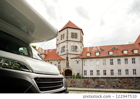 Scenic view RV Camper van stands at Moritzburg Castle in Halle am Saale Saxony-Anhalt Germany. Freedom travel motorhome lifestyle adventure road trip exploring Europe landmark historical sightseeing 122947510