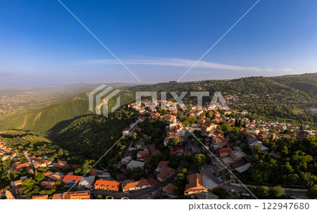Aerial view on St. George's Church and Alazani valley, Georgia, Kakheti region, Signagi village. Sighnaghi city of love on hill near Gombori Range. Drone Photography in sunny summer day. Aerial view on St. George's Church and Alazani valley, Georgia, Kakheti region, Signagi village. Sighnaghi city of love on hill near Gombori Range. Drone Photography in sunny summer day. 122947680